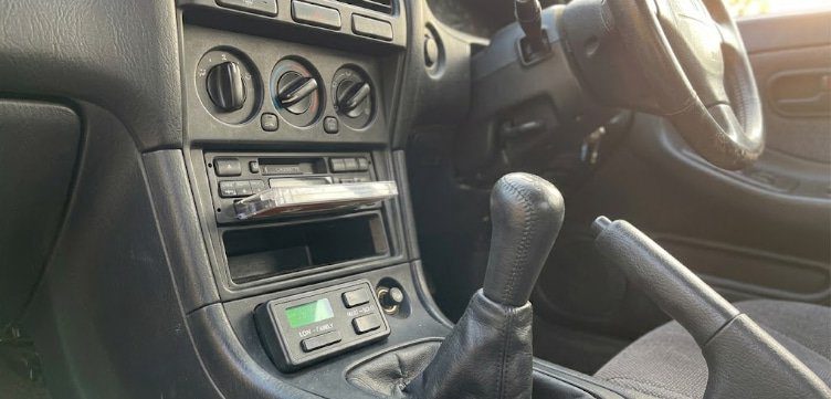 Switchable boost maps for family driving and solo driving boost controller with low and high boost settings visible in the interior of a street car