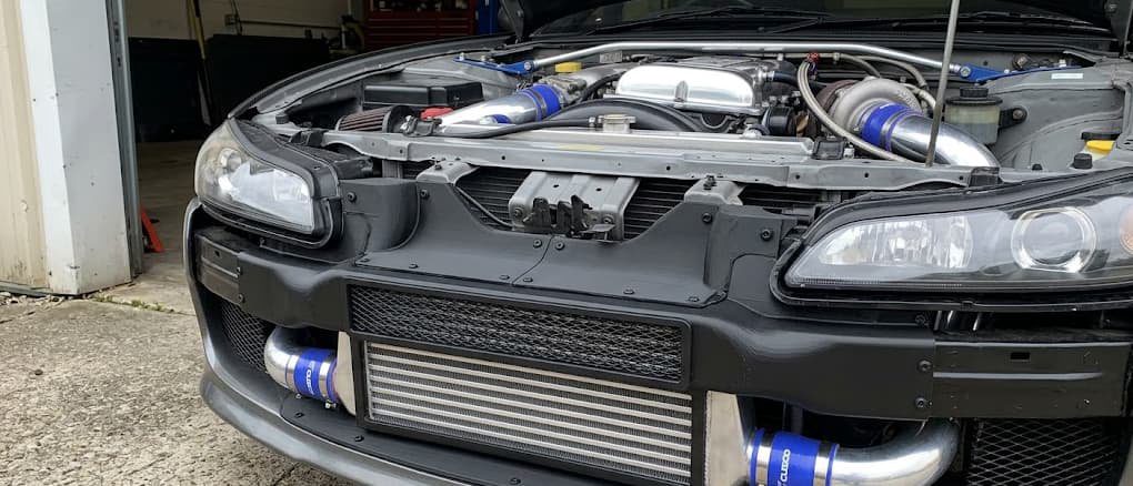 Correctly sized intercooler with sealed ducting for street performance properly sized tube-and-fin intercooler with custom ABS ducting installed in a street car